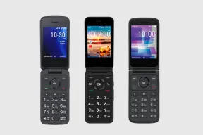 Three flip phones open side by side, each showing a clock above its keypad