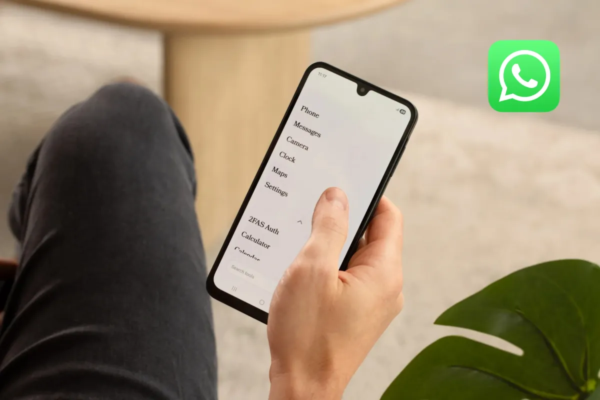 A hand holding a phone with a plain text menu of Phone, Messages, and Maps, beside a WhatsApp icon