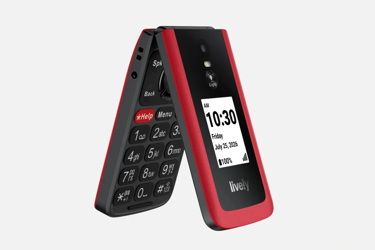 The red Jitterbug Flip3 flip phone, open to show its big keys and red Help button, with the outer screen showing the time
