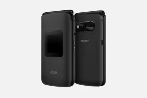 Two closed black Kazuna eTalk flip phones, one showing the small outer display and one the back with its camera