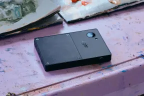 The black back of the Light Phone III, with its camera and Light logo, resting on a painted surface