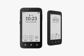 Two Mudita Kompakt phones with E Ink home screens showing the time and Phone, SMS, and Apps icons